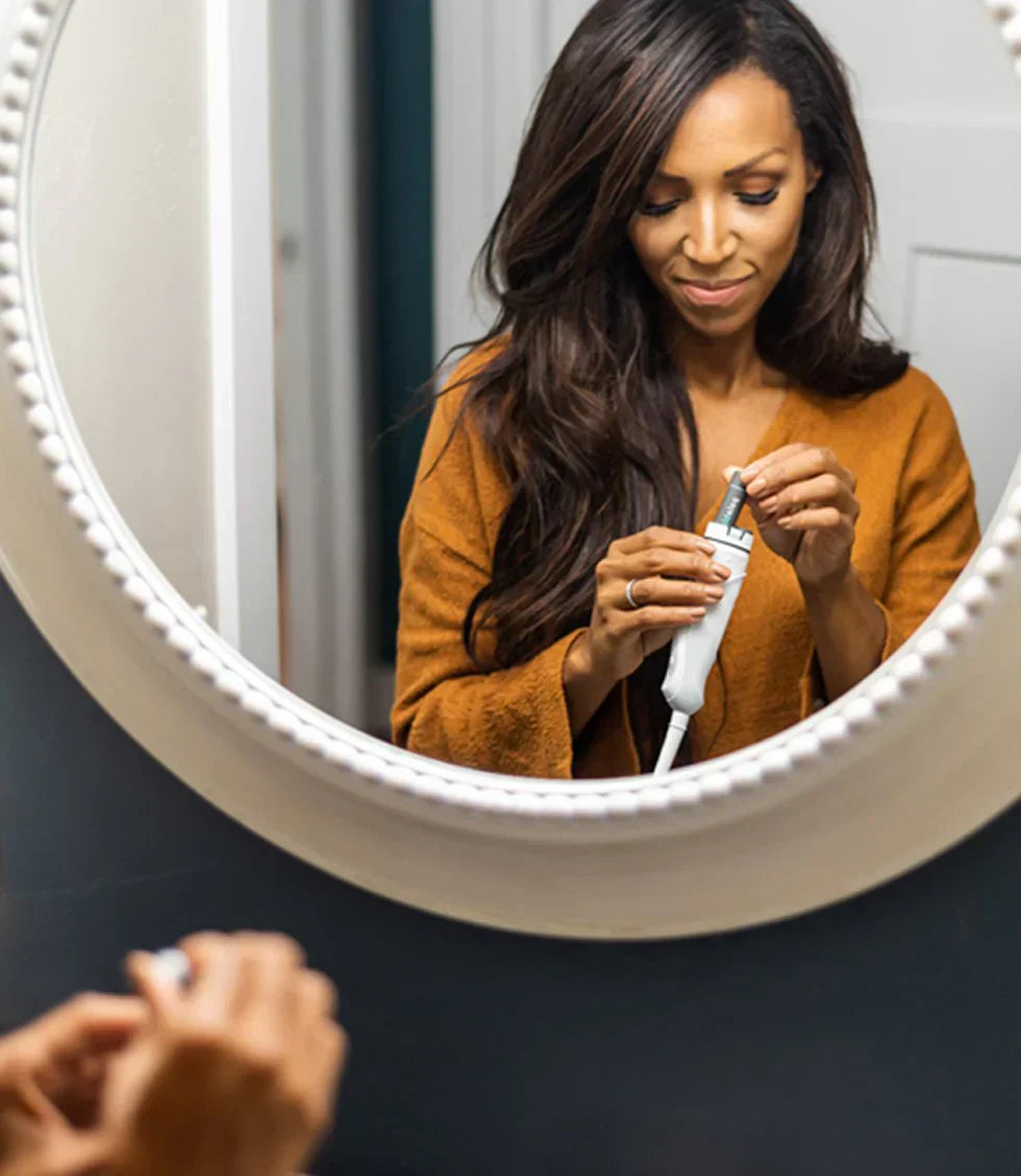Woman recharging electric toothbrush