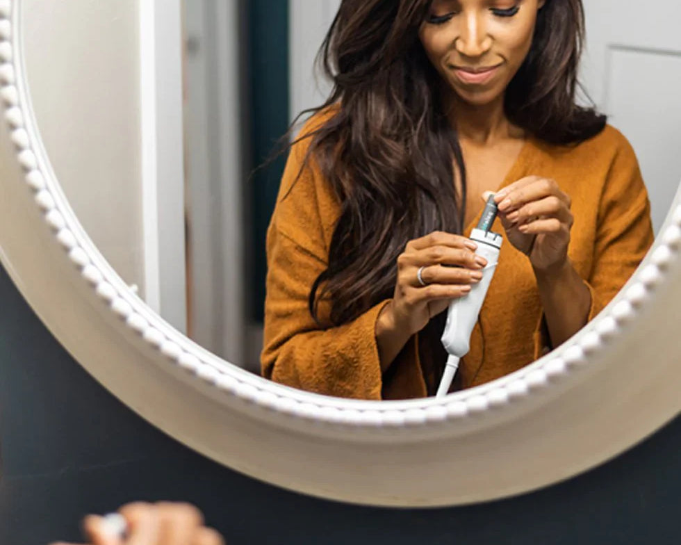 Woman recharging electric toothbrush